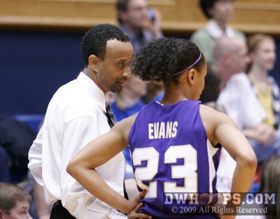 JMU Head Coach Kenny Brooks checks on star guard Dawn Evans, who was back on the floor after some health issues. -  - 
