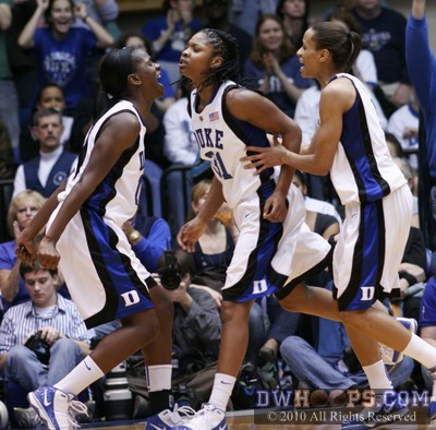 Bridgette Mitchell, Keturah Jackson, and Jasmine Thomas celebrate drawing a UConn offensive foul. -  - 