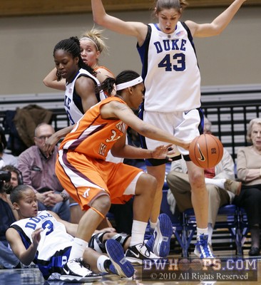 Taylor Ayres dribbles over a prone Shay Selby into a jumping Allison Vernerey -  - 