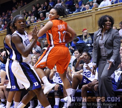 Keturah Jackson (obscured) and Bridgette Mitchell force a Nikki Davis turnover as Alexis Rogers and Duke assistant coach Trisha Stafford-Odom watch from the bench -  - 