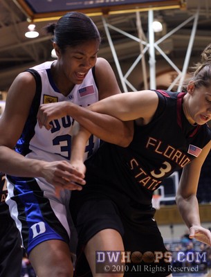 Sisters Krystal Thomas and Alexa Deluzio tangle for a loose ball on the baseline. -  - 