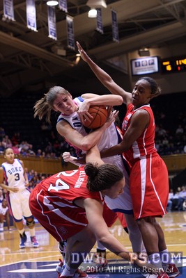Allison Vernerey (center) fends off Lucy Ellison and Nikitta Gartrell (right) while gathering in one of her seven offensive rebounds -  - 