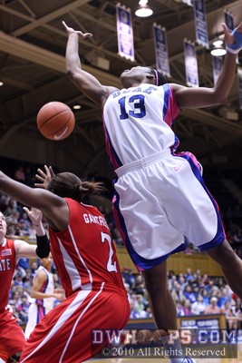 A rebound soars away from Nikki Gartrell (bottom) and Karima Christmas -  - 