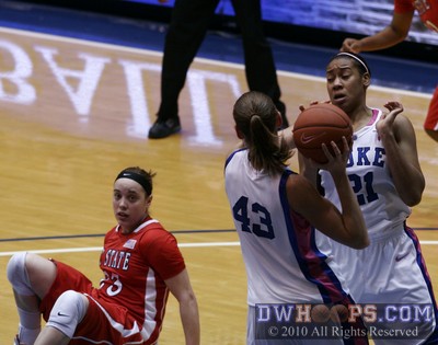Allison Vernerey wrests the ball from Duke teammate Joy Cheek while NC State's Marissa Kastanek watches from the floor -  - 