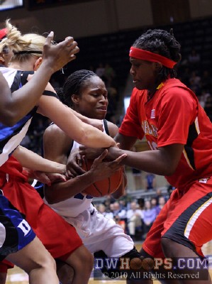 Kathleen Scheer (left), Karima Christmas, and Lynetta Kizer tie up the basketball -  - 
