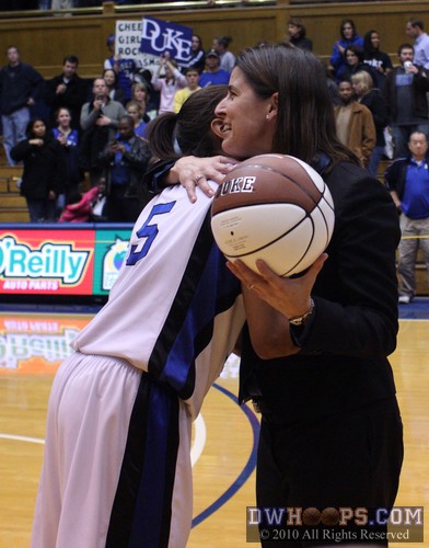 Coach P presents Jasmine Thomas with a ball commemorating her 1,000th point scored at Duke -  - 