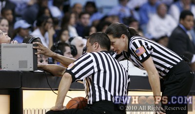Referees examine the video replay to determine if a flagrant foul occurred -  - 