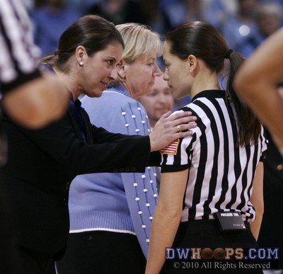 Joanne P. McCallie gets an explanation from Maj Forsberg as Sylvia Hatchell heads back to the UNC bench -  - 