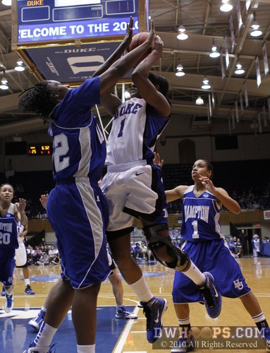 Chelsea Hopkins (1) meets the defense of Quanneisha Perry in the lane.  She would board the miss and stick it back. -  - 