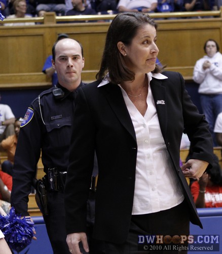 Duke Head Coach Joanne P. McCallie takes the floor, escorted by one of Duke's Finest -  - 