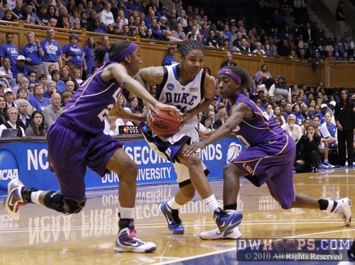 Keturah Jackson (center) drives into the double team of Allison Hightower (left) and Destini Hughes -  - 