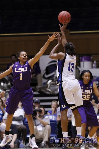 LSU's Katherine Graham extends but can't reach the three point shot of Karima Christmas.  Duke was 1-6 from distance in the first half, 1-10 overall. -  - 
