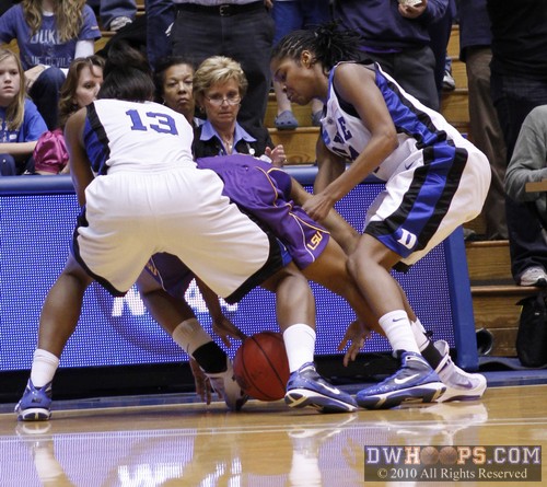 As ACC Associate Commissioner Nora Lynn Finch looks on, Keturah Jackson (right) and Karima Christmas (13) gang up on LSU's Lasondra Barrett to force a turnover -  - 