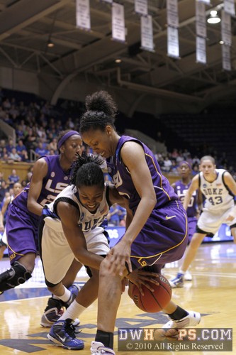 Fouled by Katherine Graham, Keturah Jackson loses the handle and reaches for the ball between Graham's legs -  - 