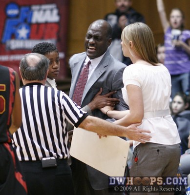 Cooper has been whistled for a technical foul at the worst possible time, his assistants restrain him so that USC doesn't get a second -  - OC;2,3:15,68-66
