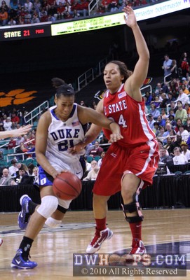 Duke's Joy Cheek and NC State's Lucy Ellison lock arms at the elbow as Cheek drives to the basket -  - 