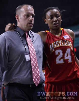Diandra Tchatchouang helped off the floor by Maryland trainer Matt Charvat after tweaking her ankle -  - 