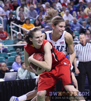 Lori Bjork grabs a rebound as Allison Vernerey giggles.  It was lucky Alli left before the elbow came up. -  - 