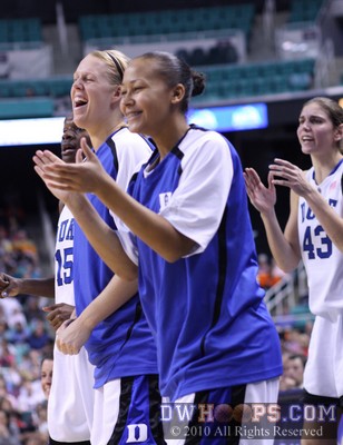 Kathleen Scheer (left), Shay Selby, and Allison Vernerey (right) applaud Duke's efforts from the bench -  - 