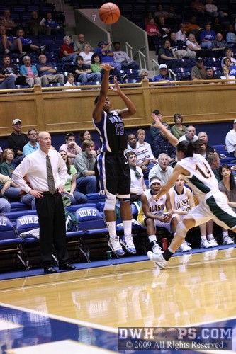 Another swish from behind the arc for Karima Christmas, UAA head coach Tim Moser can only watch -  - 