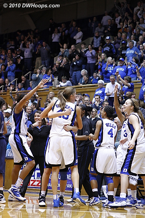 Allison Vernerey is embraced by Haley Peters in the joyous Duke huddle.