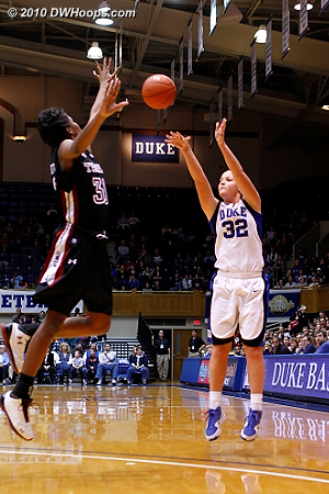 Tricia Liston fires a three point try over Marli Bennett