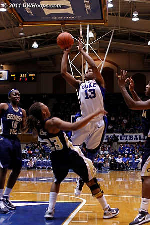 Deja Foster draws a charge from Karima Christmas.  - Duke Tags: #13 Karima Christmas 