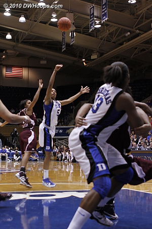 Players jockey for position under the basket; the shot clock buzzer sounds with J.Thomas shot still airborne.  