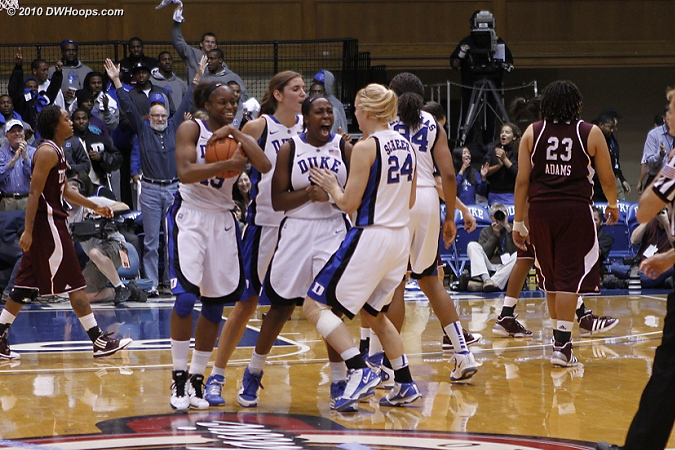 Karima Christmas cradles the game ball as Chelsea Gray tells Kathleen Scheer how happy she is.  - Duke Tags: #12 Chelsea Gray, #13 Karima Christmas 