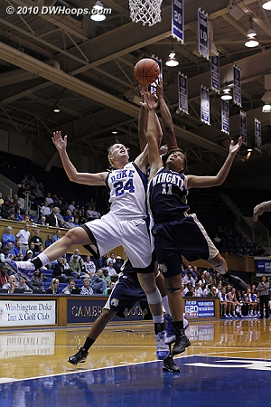 Kathleen Scheer goes high for a rebound, battling with Janitsha Williams (#11)