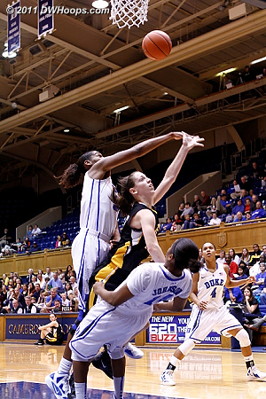 Ka'lia Johnson draws a charge as Amber Henson swats the ball away