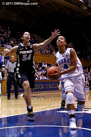 Chloe Wells breaks to the basket as Samantha Woods (54) can't catch her