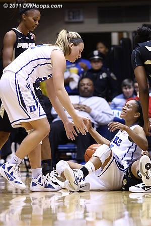 Tricia Liston helps Chloe Wells up after the latter forced a tieup  - Duke Tags: #4 Chloe Wells, #32 Tricia Liston 