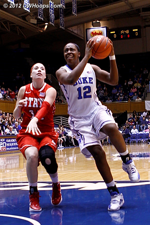 Chelsea Gray drives past Elimi Tasler (11) to score the opening basket