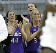  - Holy Cross players applaud Brittany Keil's 1,000 point achievement