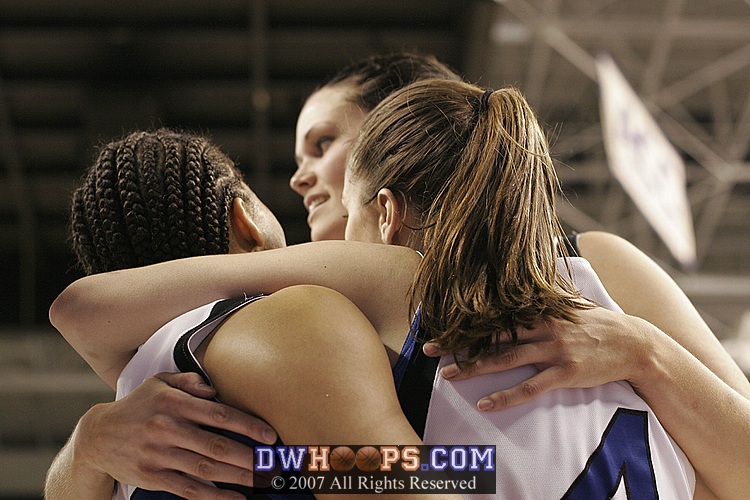 A hug for Nish from Abby and Alison after her layup drops, and she is fouled