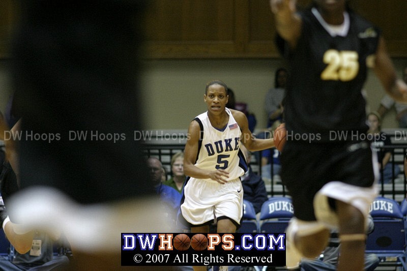 Jasmine Thomas at the point brings the ball upcourt