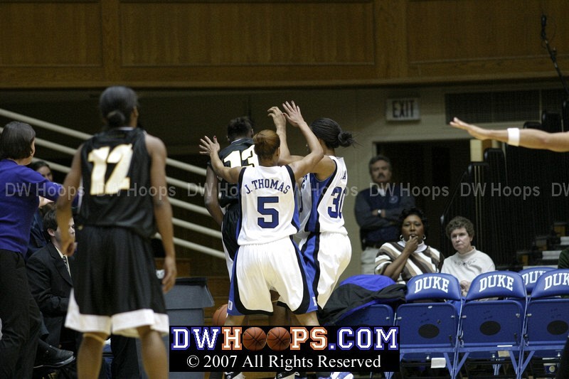 Jasmine Thomas and Carrem Gay force Dominique Redding into a turnover