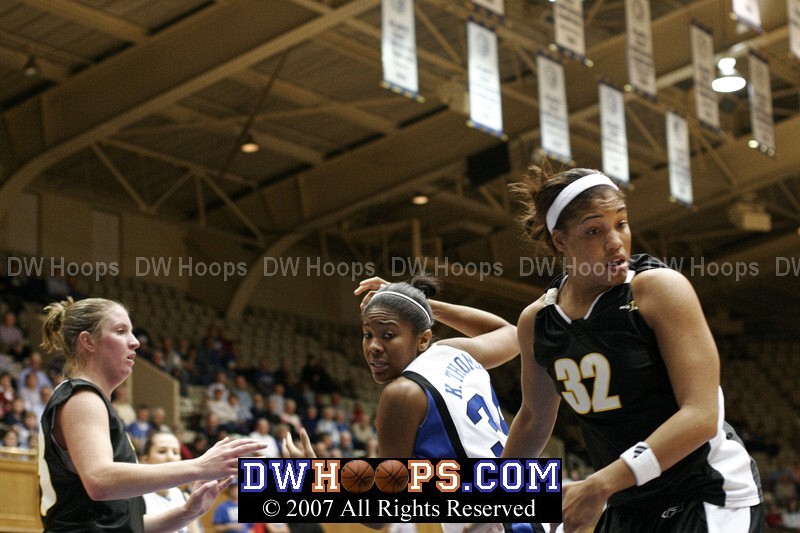 Duke's Krystal Thomas and Courtney McDaniel (right) look for the ball