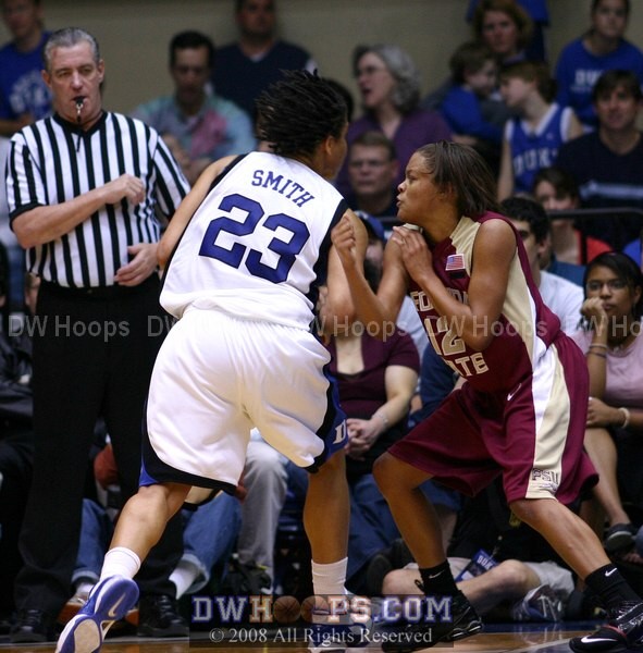 Wanisha Smith drives on Courtney Ward as Dennis DeMayo looks on