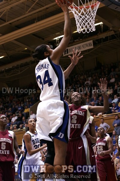 Krystal Thomas scores easily over guard Alysha Harvin