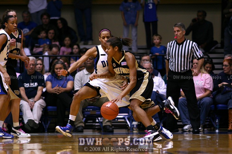 Brittany Waters drives into Jasmine Thomas, who would block her shot