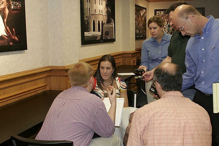 Abby Waner surrounded by journalists