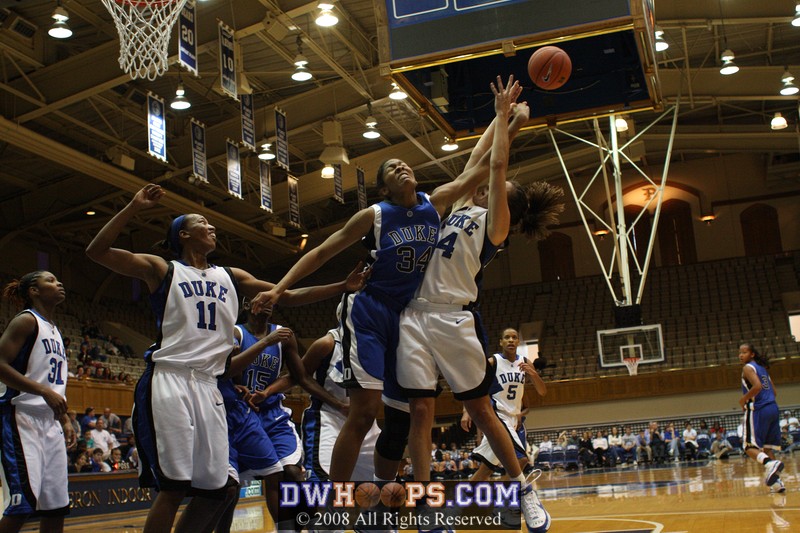 Krystal Thomas and Abby Waner battle for the rebound after Chante's block