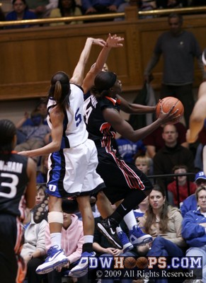 Charmaine Clark twists to the basket and is fouled by Shay Selby (hidden) - her free throws cut Duke's lead to just 5