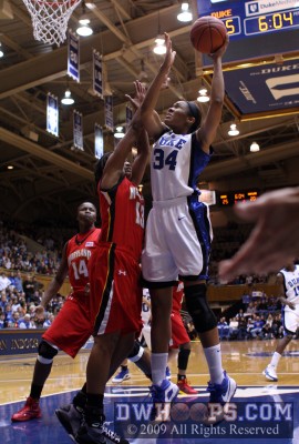 Krystal Thomas protects the ball from Liles and scores
