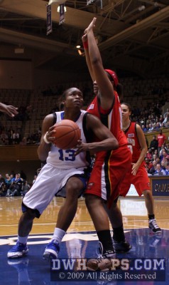 Karima Christmas twists down the lane for a rebound basket -  - D13, 2, 7:13, 58-55