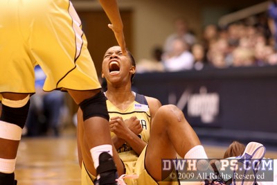 A primal scream by Shaday Woolcock after drawing a charge from Duke's Abby Waner (right, prone)