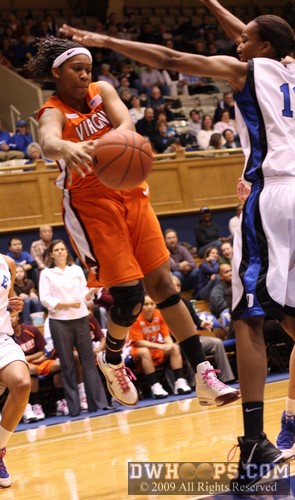 Shanel Harrison pops a pass into the low post under the outstretched arm of Chante Black