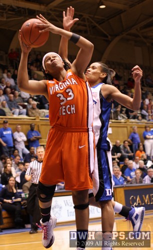 Jasmine Thomas tries to erase a Shanel Harrison shot from behind